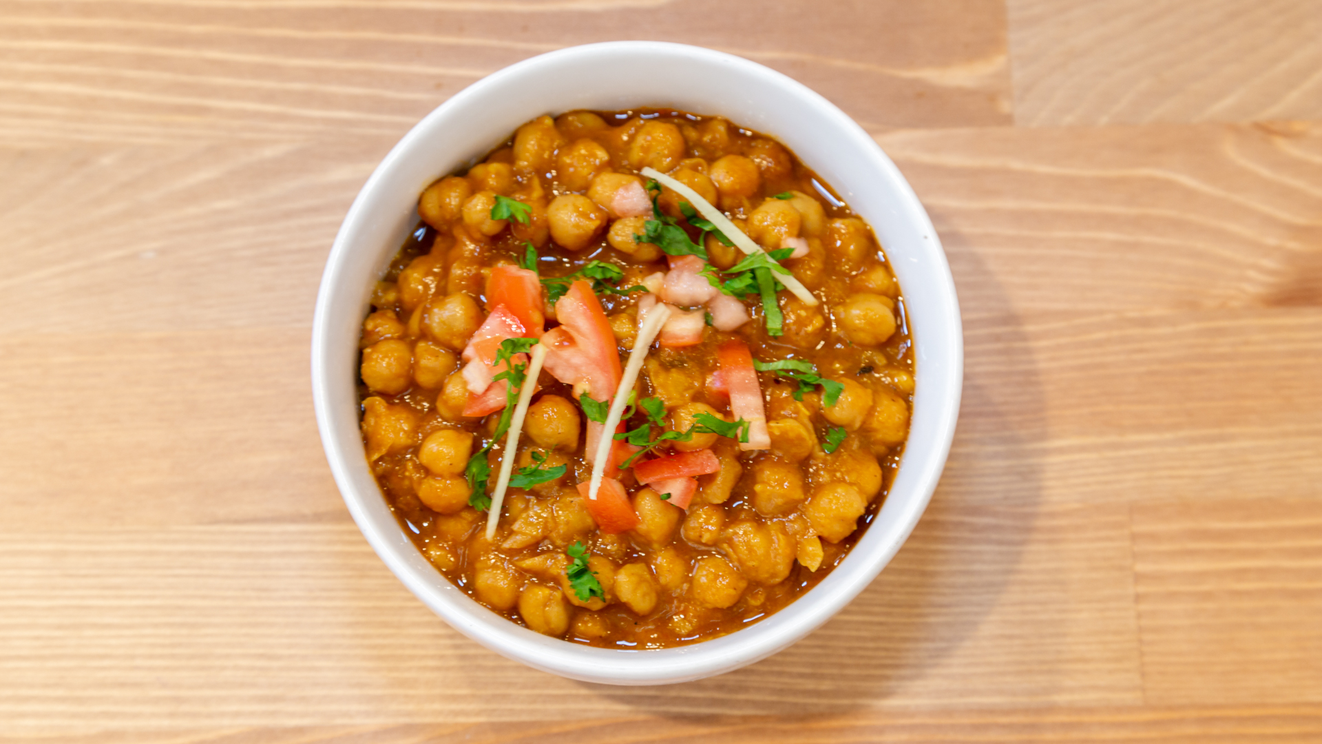 Sundara chana masala with tomato, ginger, and cilantro
