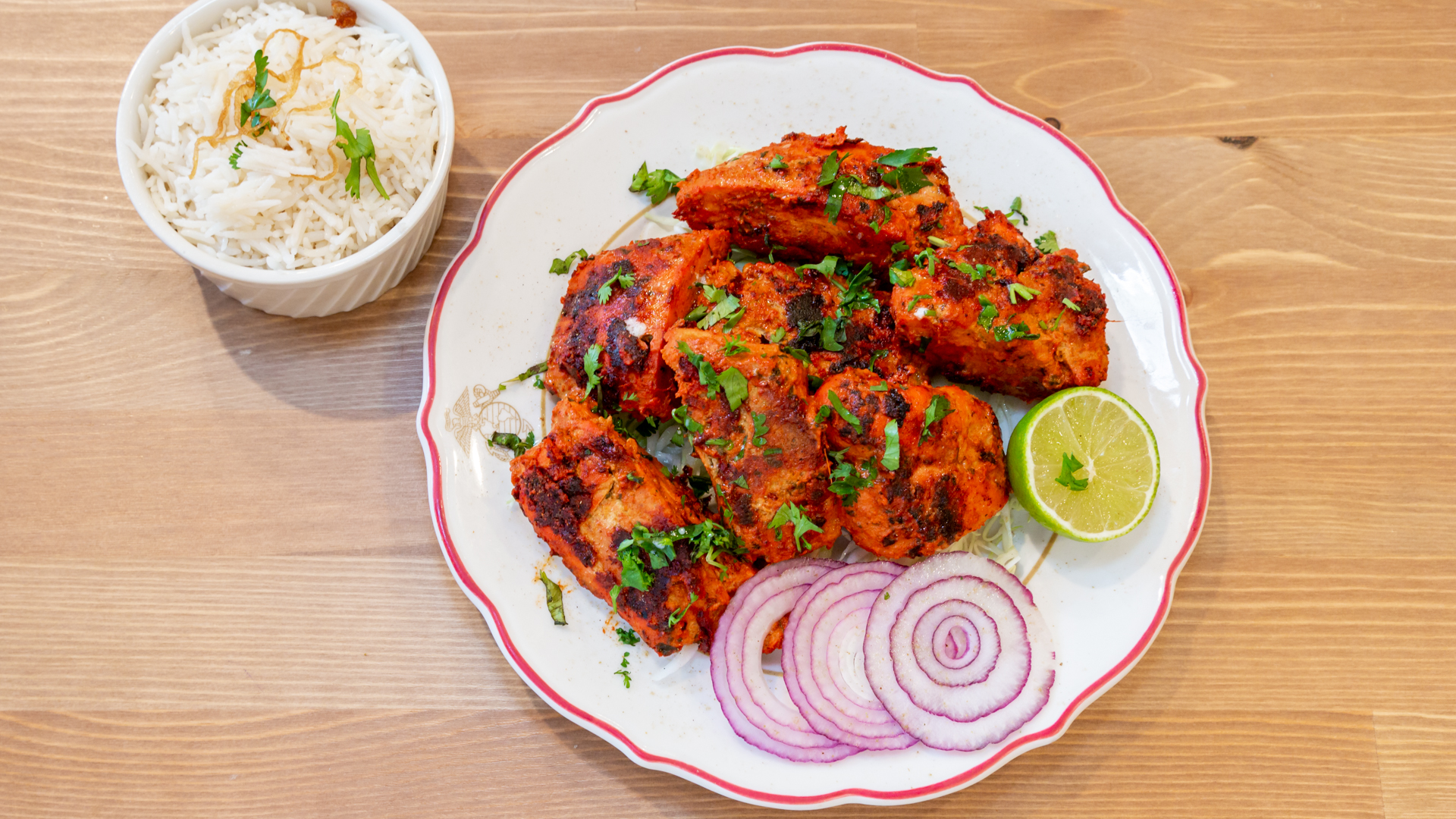 Sundara tandoori chicken with rice, lime, and onion